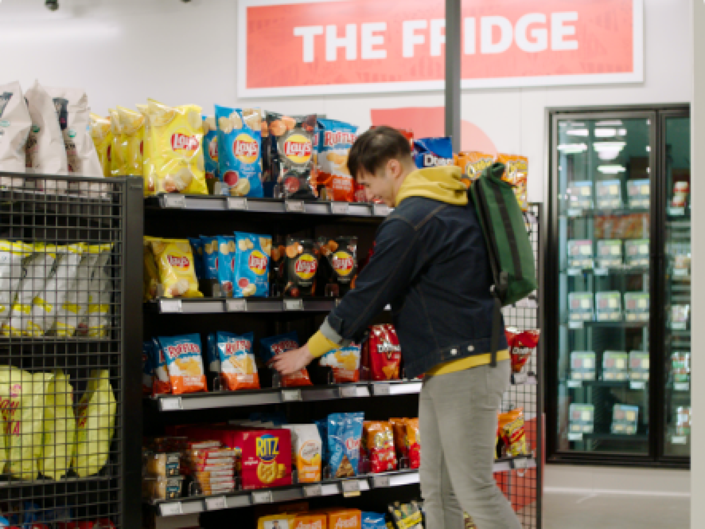 man selecting chips in store